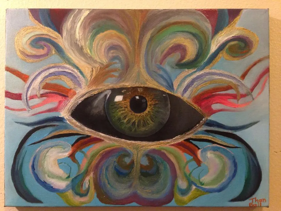 Large eye at the center of ornate swirling shapes in blue, red and gold