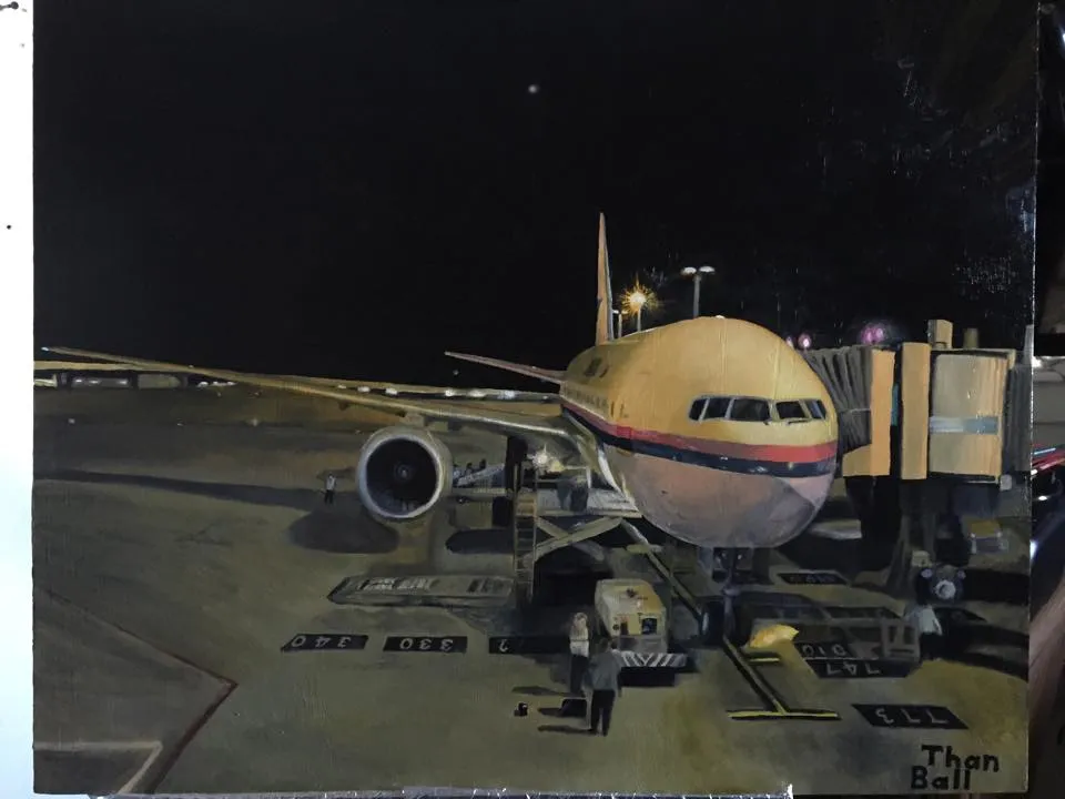 Night scene of a passenger jet parked at an airport gate